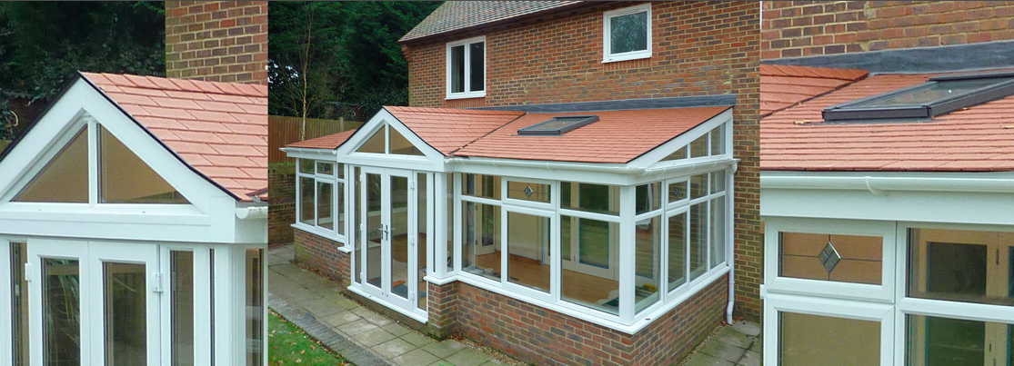 A house featuring a conservatory and a sloped roof, surrounded by greenery.